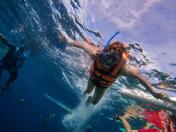 High angle view of woman swimming in sea