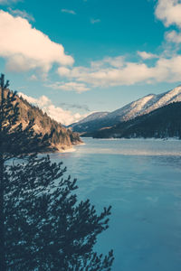 Scenic view of lake and mountains against sky