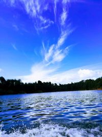 Scenic view of lake against blue sky