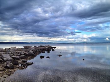 Scenic view of sea against cloudy sky