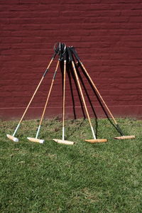 High angle view of metallic structure on field against wall