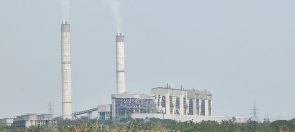 Low angle view of smoke stack against sky