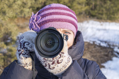 A photographer girl with a camera in winter