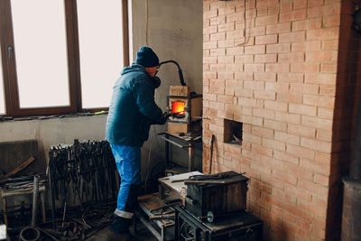 Rear view of man working at construction site