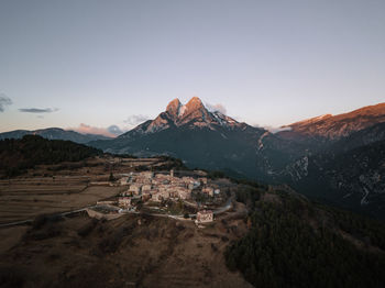 High angle view of village against snowcapped mountain range