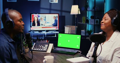 Side view of young woman using laptop on table