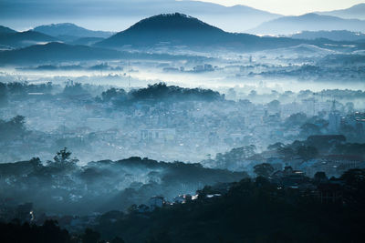 Scenic view of cityscape in fog