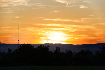 Scenic view of silhouette trees against sky during sunset