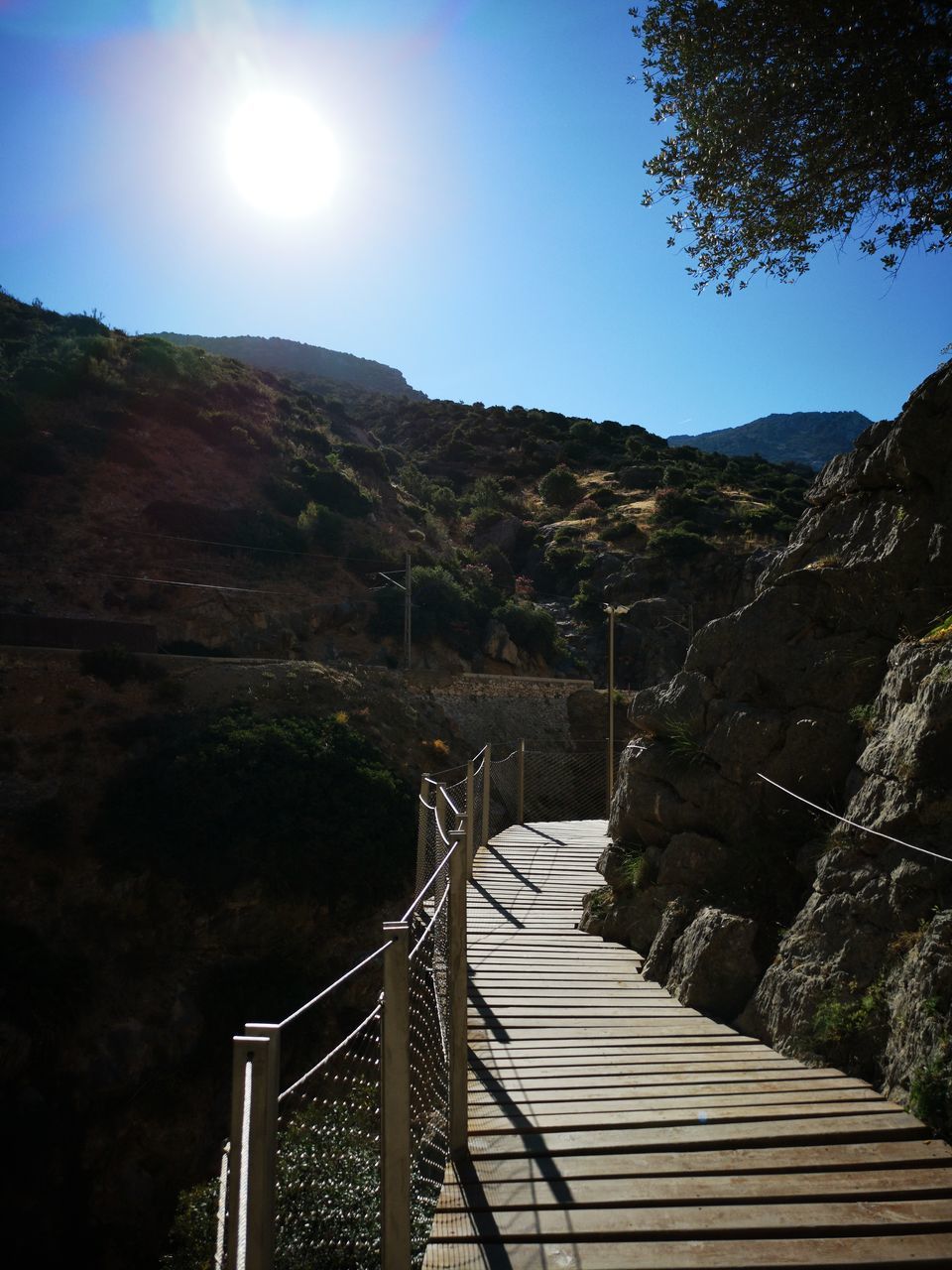 FOOTBRIDGE LEADING TOWARDS MOUNTAINS