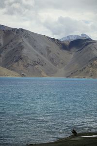 Scenic view of mountains against cloudy sky