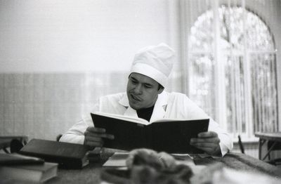 Man reading book at table
