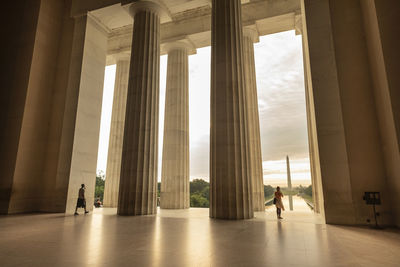 People walking in corridor of building