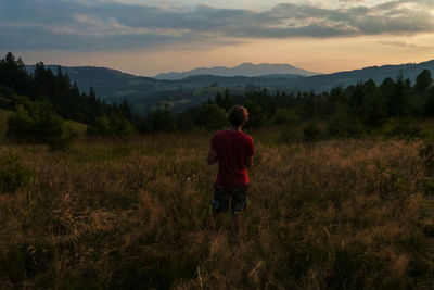Rear view of man standing on field