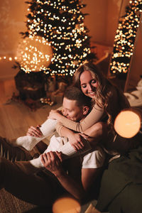 A romantic couple in love celebrates christmas holidays and new year in a cozy house at night