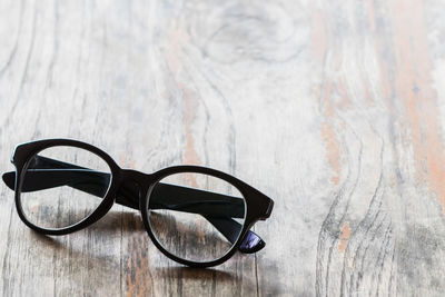 Close-up of eyeglasses on wooden table