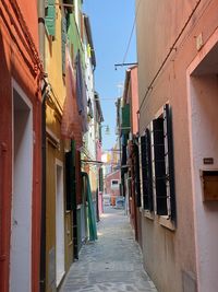 Narrow alley amidst houses and buildings in city