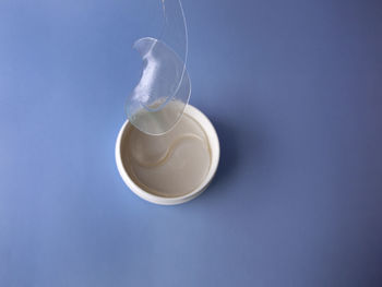 Close-up of tea cup against blue background