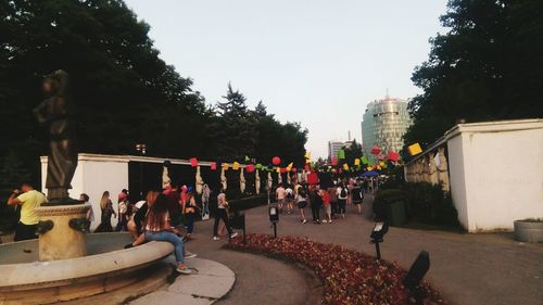 People on street against sky