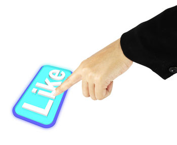 Close-up of hand holding smart phone over white background