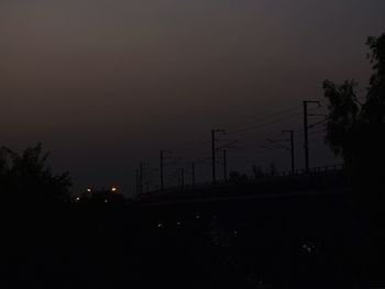 Silhouette trees against sky at night