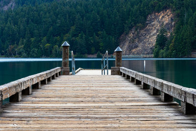 Pier over lake against trees and mountains cresent lake