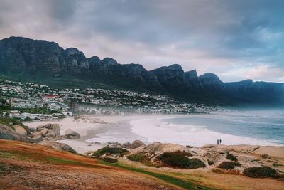 Beach against cloudy sky