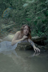 Full length of woman sitting in water