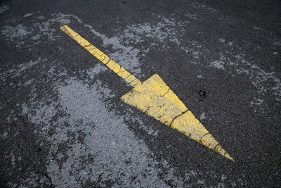 High angle view of arrow sign on road