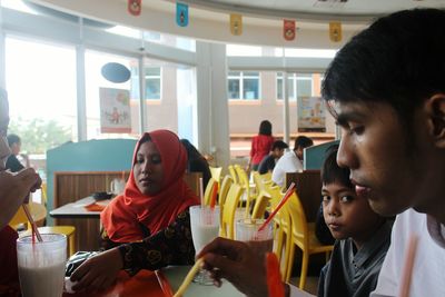 Young man and woman sitting at market