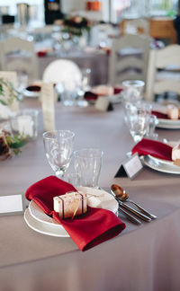 High angle view of plates and wineglasses on table 