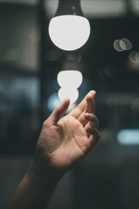 Close-up of hand holding illuminated light