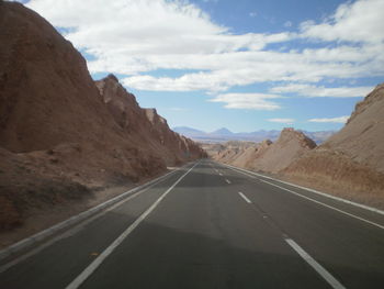 Empty road leading towards mountains