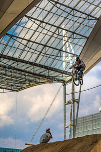 Low angle view of man riding bicycle