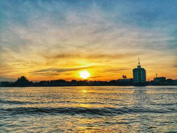 View of sea against cloudy sky during sunset