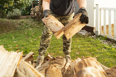 Low section of woman standing on wood