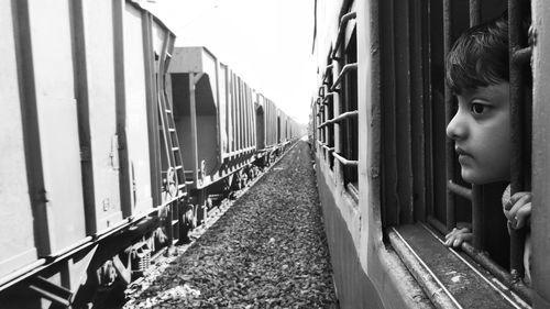 Portrait of girl on railroad track amidst train.. captive childhood 