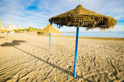 Umbrellas on beach against sky