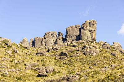 Rock formations on landscape against clear sky