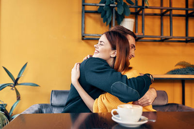 Young woman sitting with coffee cup in cafe