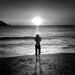 Silhouette of people standing on beach