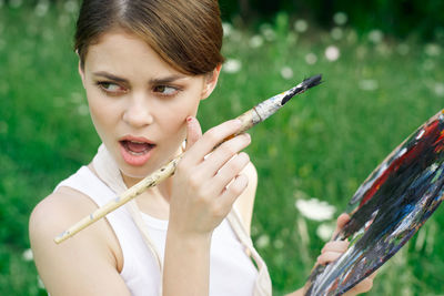 Portrait of young woman using mobile phone