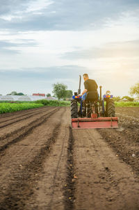 A farmer grinds up solid soil to plant new crops. development of agricultural economy