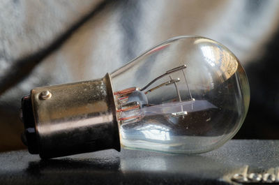 Close-up of light bulb on table