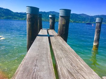 Wooden jetty in sea against sky