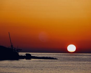 Scenic view of sea against orange sky