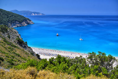 High angle view of sea against blue sky