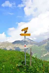 View of sign on mountain against sky