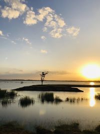 Scenic view of lake against sky during sunset