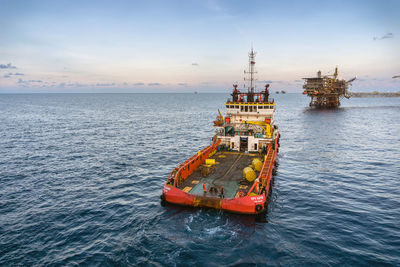 Ship sailing on sea against sky