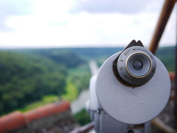 Close-up of coin-operated binoculars against sky